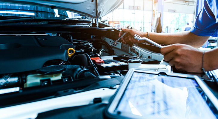 Auto mechanic are checking the condition of the car according to